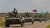 Бронированный конвой российских войск въезжает в оккупированную Россией часть Запорожской области Украины, 23 июля 2022 года
