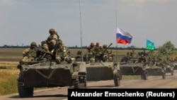 An armored convoy of Russian troops drives through the Russian-held Zaporizhzhya region on July 23.