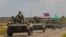 An armored convoy of Russian troops drives through the Russian-held Zaporizhzhya region on July 23.