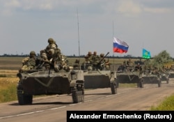 An armored convoy of Russian troops drives in a Russian-occupied part of Ukraine’s Zaporizhzhya region on July 23.