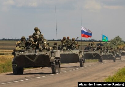 An armored convoy of Russian troops drives in a Russian-occupied part of Ukraine’s Zaporizhzhya region on July 23.