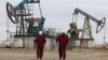 Workers walk near oil pumps at the Uzen oil and gas field in the Mangistau region of Kazakhstan. (file photo)