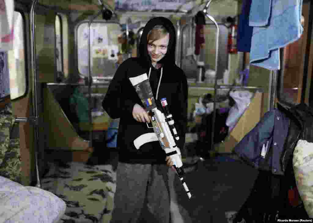 Oleksandr Romanenko, 13, plays with a toy gun he made out of the packaging from aid donations. The boy was photographed in a subway carriage serving as a makeshift bomb shelter&nbsp;in the eastern city of Kharkiv on April 28.&nbsp;