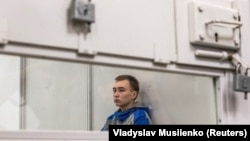 Vadim Shishimarin sits inside a cage during an appeals court hearing in Kyiv on July 25.