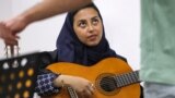 Wejdan Hajji, a 28-year-old employee at a firm selling medical supplies, attends a guitar class at the Yamaha Music Centre in Saudia Arabia's capital Riyadh on June 11, 2022.