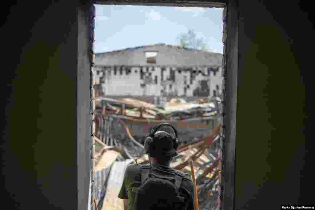 Artem surveys shattered buildings from his vantage point at the front line in the Kharkiv region.&nbsp; Russian forces have taken complete control of the Luhansk region and a large portion of the Donetsk region since Russia launched its invasion in February.