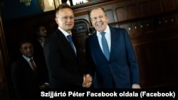 Hungarian Foreign Minister Peter Szijjarto (left) greets Russian counterpart Sergei Lavrov during a visit to Moscow in July.