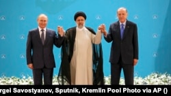 Russian President Vladimir Putin, Iranian President Ebrahim Raisi, and Turkish President Recep Tayyip Erdogan pose for a photo prior to their talks at the Saadabad Palace in Tehran on July 19.