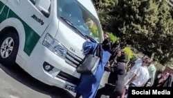 In a video of the incident, the girl's mother can be seen standing in front of a police van trying to stop it from leaving with her daughter.
