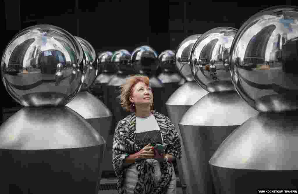 A woman views an installation titled Echo In Moscow by Canadian artist Husam Chaya installed between the towers of the Moscow City&nbsp;business center in Moscow.