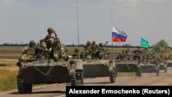 An armored convoy of Russian troops drives in the Russian-held part of Ukraine's Zaporizhzhya region on July 23.