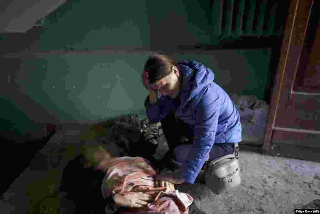 Nina Shevchenko mourns next to the body of her 15-year-old son, Artyem Shevchenko, who was killed in a Russian strike on Kharkiv on April 15.&nbsp;