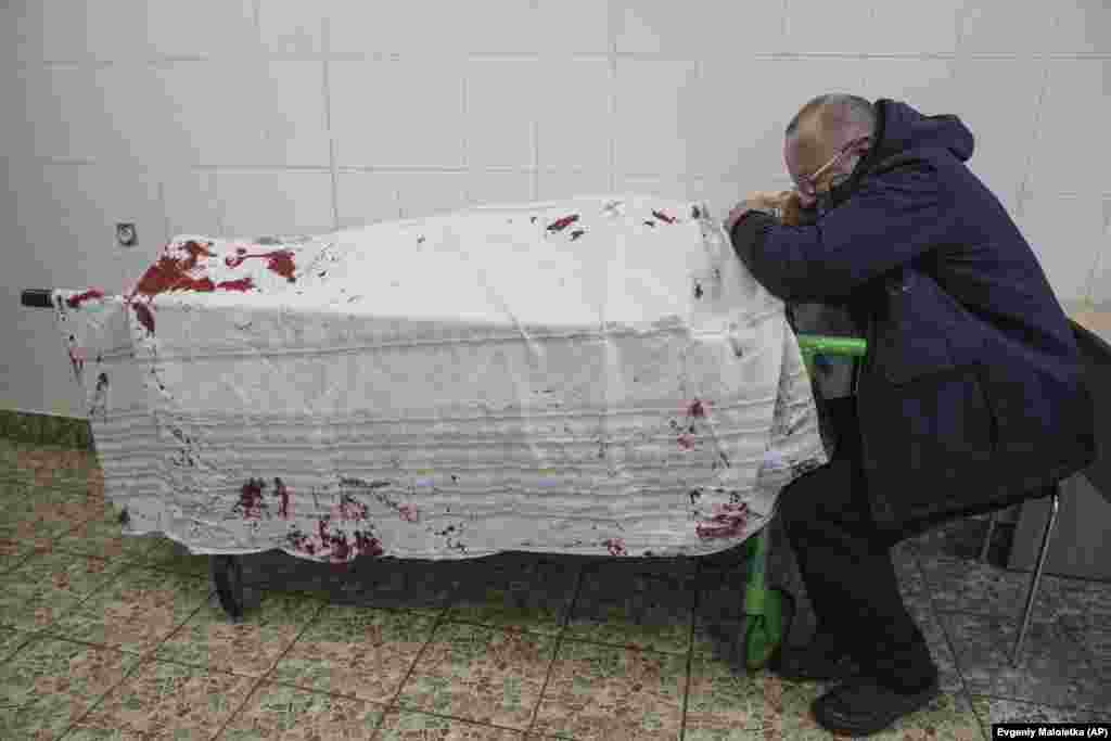 A man cries over the the body of his teenage son, Iliya, at a maternity hospital converted into a medical ward in Mariupol on March 2.