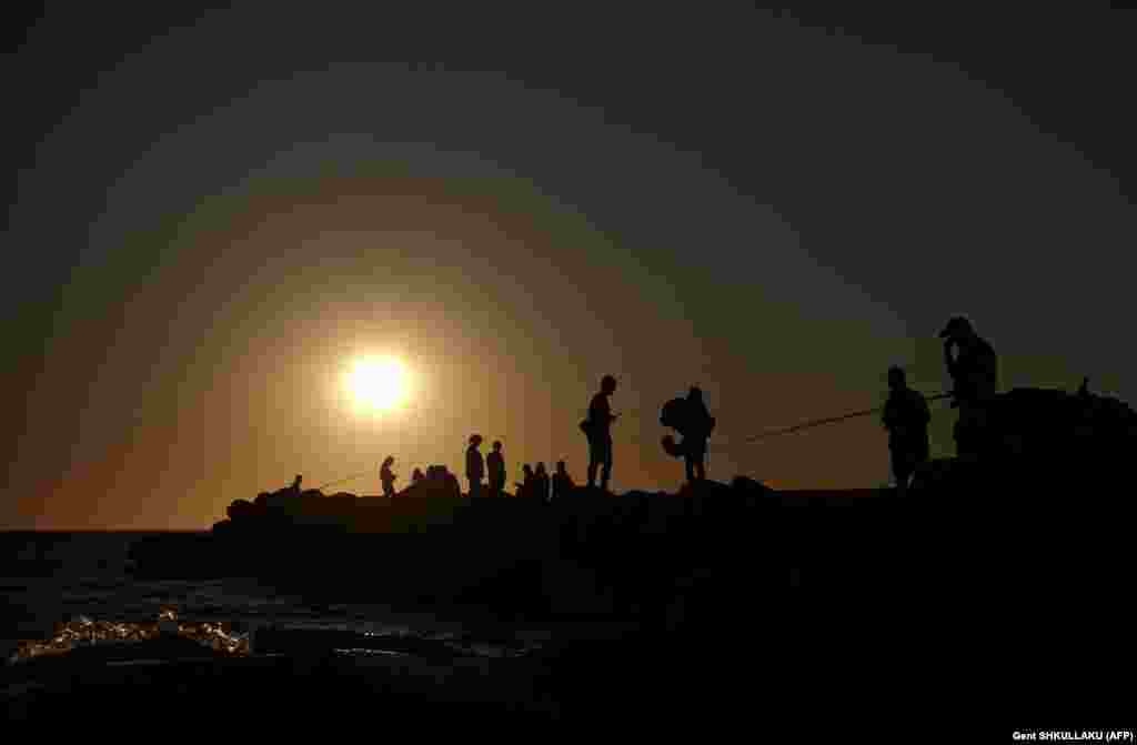 Fishermen work at sunset on the beach of Golem, near Kavaja, Albania, on July 11.