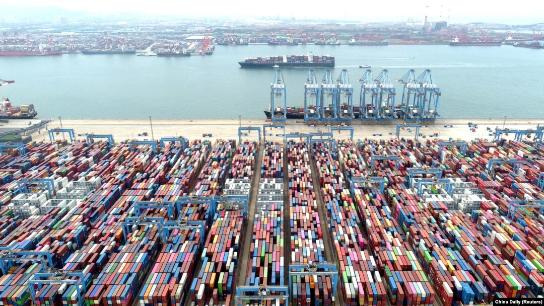An aerial view shows containers and cargo vessels at the Qingdao port in China’s Shandong Province in May. 