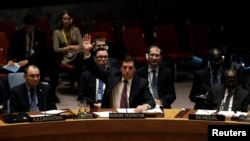 Moscow's Deputy Ambassador to the UN Vladimir Safronkov (center) voted against the UN Security Resolution to impose sanctions on Syrian officials. 