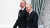 Russian President Vladimir Putin (right) and Azerbaijani President Ilham Aliyev arrive for a meeting in Moscow on April 22.