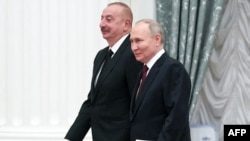 Russian President Vladimir Putin (right) and Azerbaijani President Ilham Aliyev arrive for a meeting in Moscow on April 22.