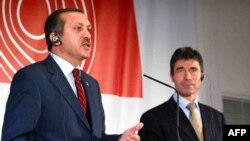 Turkey's Recep Tayyip Erdogan (left) has come out against the candidacy of Danish Prime Minister Anders Fogh Rasmussen as NATO chief.