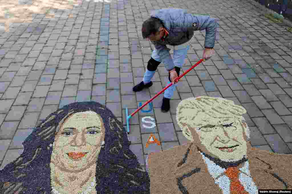  Kosovar artist Alkent Pozhegu works on mosaic made of grains showing portraits of the Democratic presidential nominee, U.S. Vice President Kamala Harris, and Republican presidential nominee and former U.S. President Donald Trump, in Gjakova, Kosovo, on November 5. 