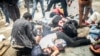 Injured protesters lie on the ground as Turkish riot police fire tear gas to disperse demonstrators gathered near Taksim Square in Istanbul in May 2014.