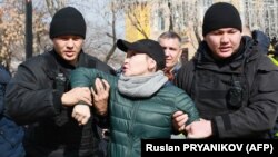 Kazakh police detain a protester in Almaty on February 22.