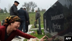 A woman cries at the grave of a relative killed during the April 2010 uprising at the Ata-Beyit cemetery, some 20 km outside the capital Bishkek, on April 7.