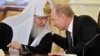 Московський патріарх Кирило слухає президента Росії Володимира Путіна. Фото від 2012 року