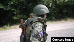 A young Japanese cosplayer wearing a badge of the separatist People’s Militia of the Donbas, which was listed as a terrorist organization in Ukraine