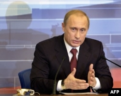 Russian President Vladimir Putin answers questions during his annual press conference at the Kremlin in December 2004.