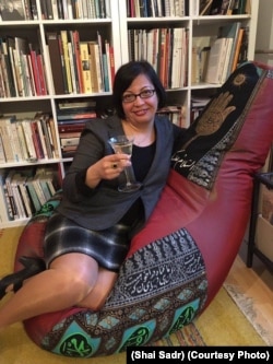 Rights activist Shadi Sadr sits on a chair featuring Islamic motifs that was created by Forouhar.