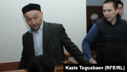 Kenzhebek Abishev (left) is seen in court during his trial in September 2018.