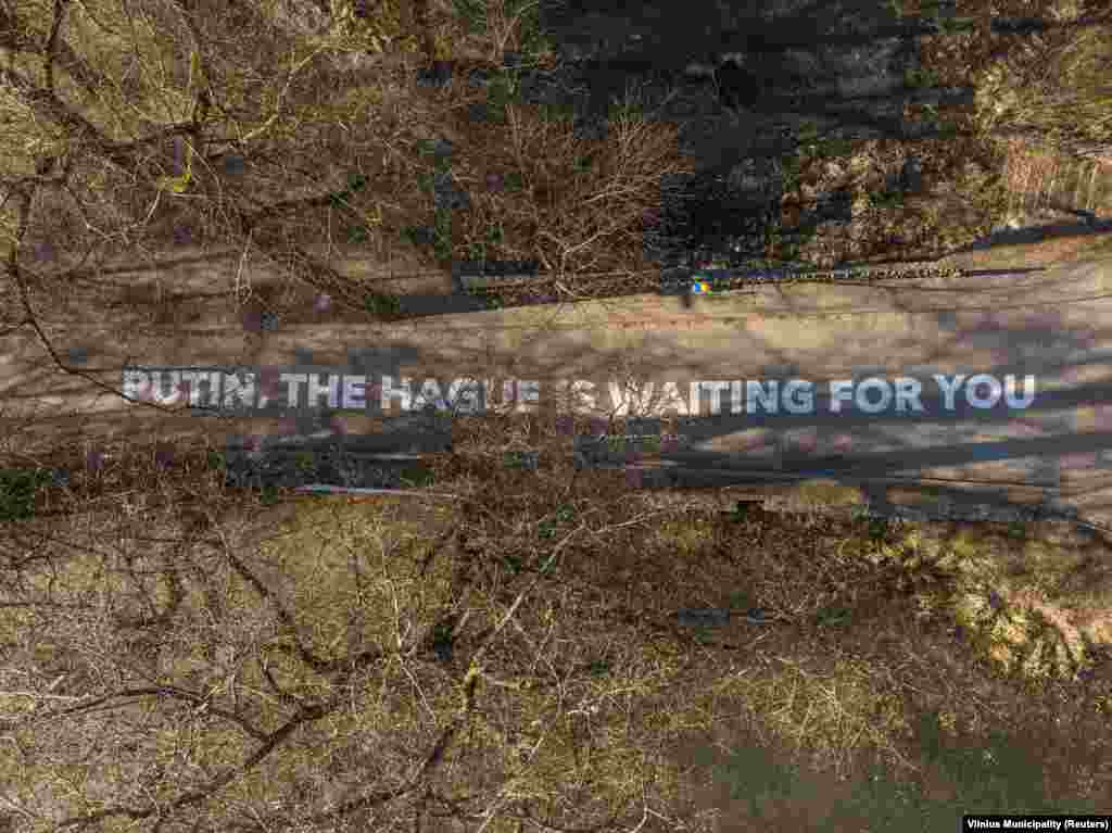 A stencilled message to the Russian president outside the Russian Embassy in Vilnius, Lithuania, photographed in February 2022