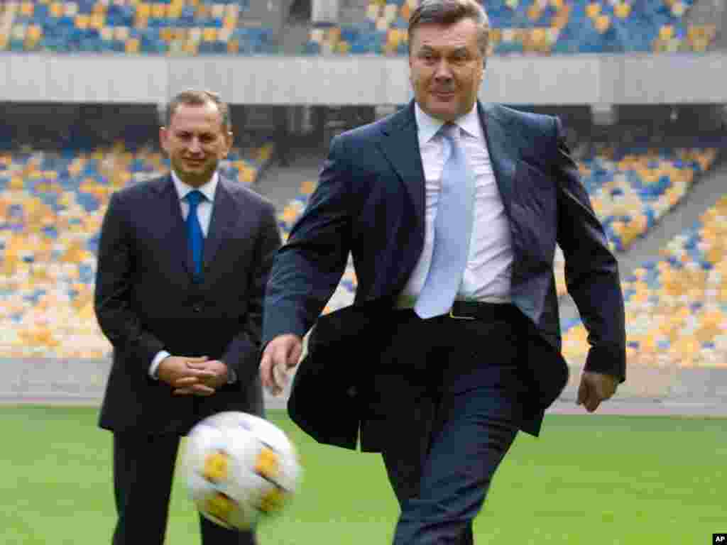 Ukrainian President Viktor Yanukovych kicks a ball during a visit to the Olympiyskiy national stadium, Kyiv, on September 23. The stadium will be the venue for the final of the Euro 2012 soccer tournament. (Photo taken by Mykhailo Markiv for AP)