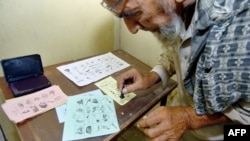 A Pakistani man marks his ballot in Karachi during elections in August 2005.