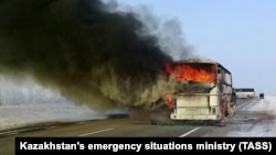 The burning bus is seen by the side of the highway near Aqtobe.