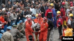 Turkey -- Rescuers carry a miner who sustained injuries after a mine explosion, to an ambulance in Soma, a district in Turkey's western province of Manisa May 14, 2014.