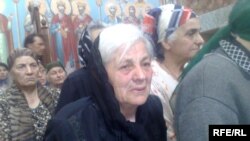  A woman stands in line for humanitarian aid at a church in Gori on August 17.