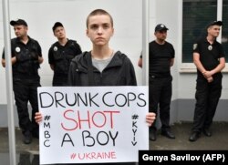 A protester holds a placard during a demonstration in front of the Interior Ministry in Kyiv on June 4.