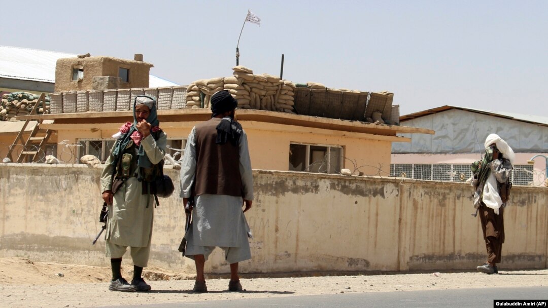 Taliban fighters stand guard in the city of Ghazni on August 13.