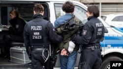 German police arrest a protester following clashes between Pro-Kurdish and Turkish demonstrators at Duesseldorf airport.