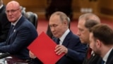 Russian President Vladimir Putin organizes documents at a bilateral meeting with Chinese leader Xi Jinping in Beijing on September 2. 