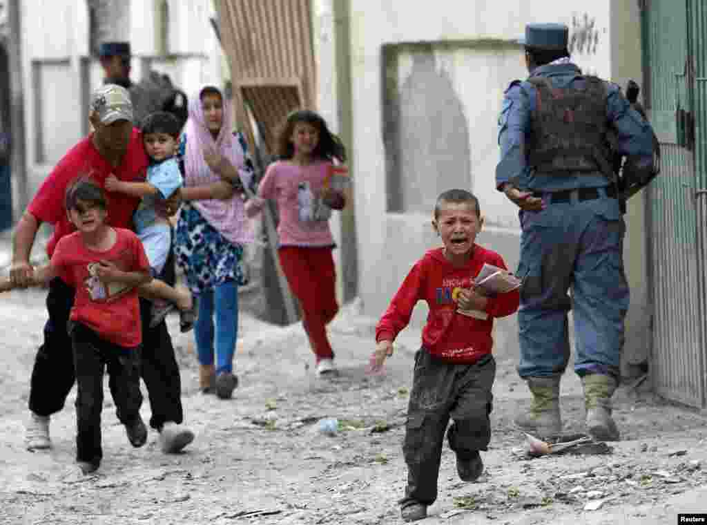 Children run from the site of an explosion in Kabul on May 24.