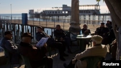 Georgia -- People enjoy the sun on the embankment of the Black Sea in Sukhumi, the capital of Georgia's breakaway region of Abkhazia, December 25, 2013