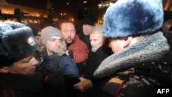 Russian police arrest opposition leader Eduard Limonov (second from right) during a protest in central Moscow on December 31.