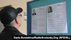 A voter in Cherkassy checks the candidate list.