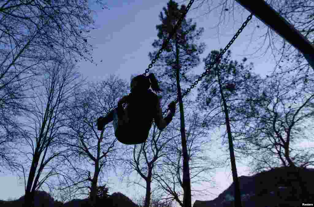 A girl rides a swing in the town of Tkvarcheli, some 50 kilometers southeast of Sukhumi.