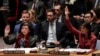 U.S. -- Karen Pierce (L), British Ambassador to the United Nations, and Nikki Haley, United States Ambassador to the United Nations, vote in favor of a resolution for an independent investigation on the use of chemical weapons in Syria, New York, April 10