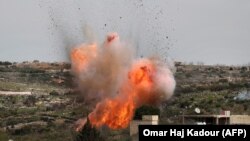 An explosion is seen following Russian air strikes in a village in Syria's Idlib Province ahead of a cease-fire on March 5.