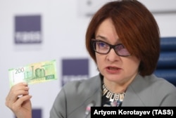 Russian Central Bank Governor Elvira Nabiullina presents the new 200 ruble banknote in Moscow on October 12.